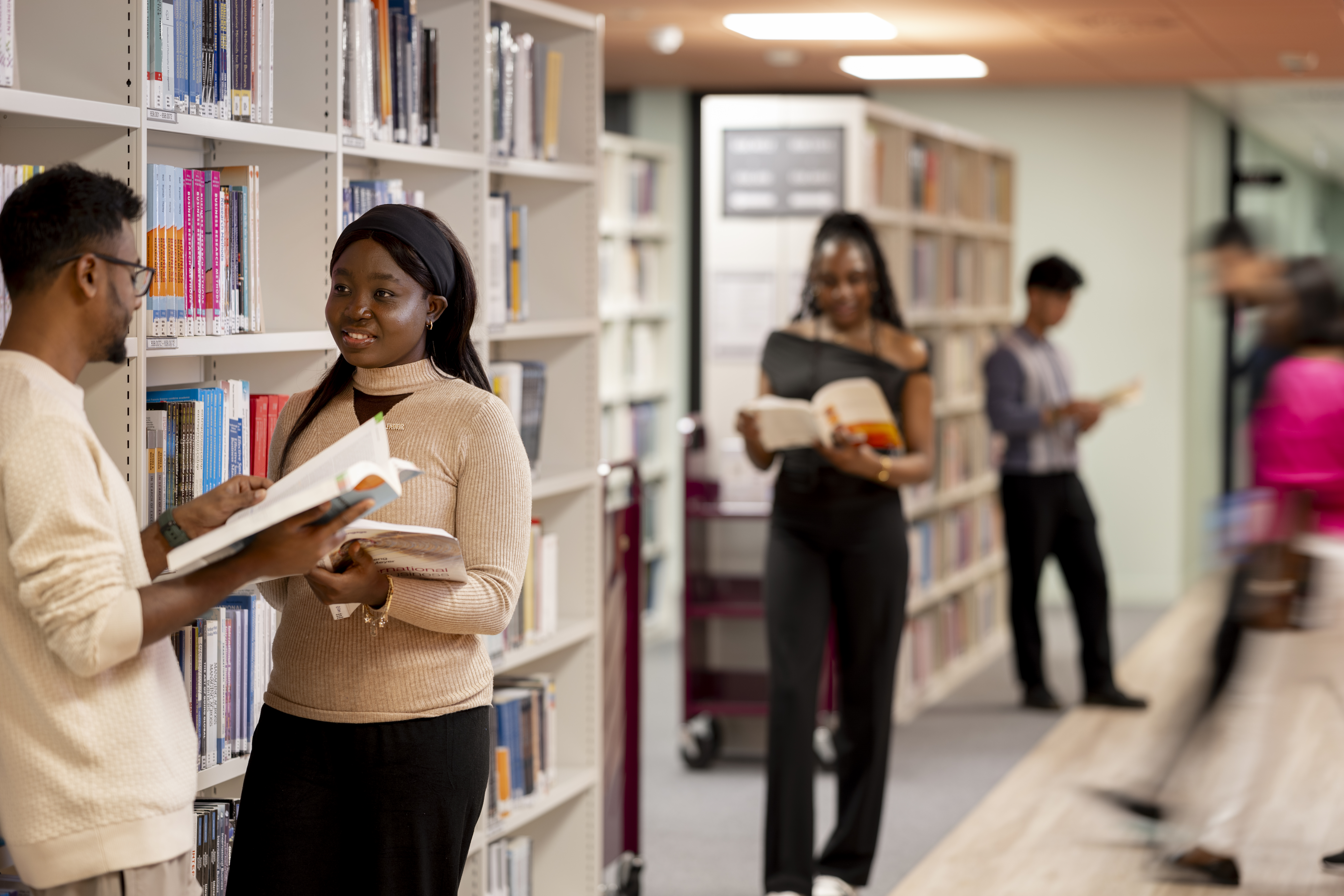 A group of students amongst bookshelves