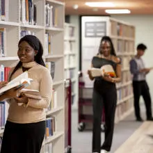 A group of students amongst bookshelves