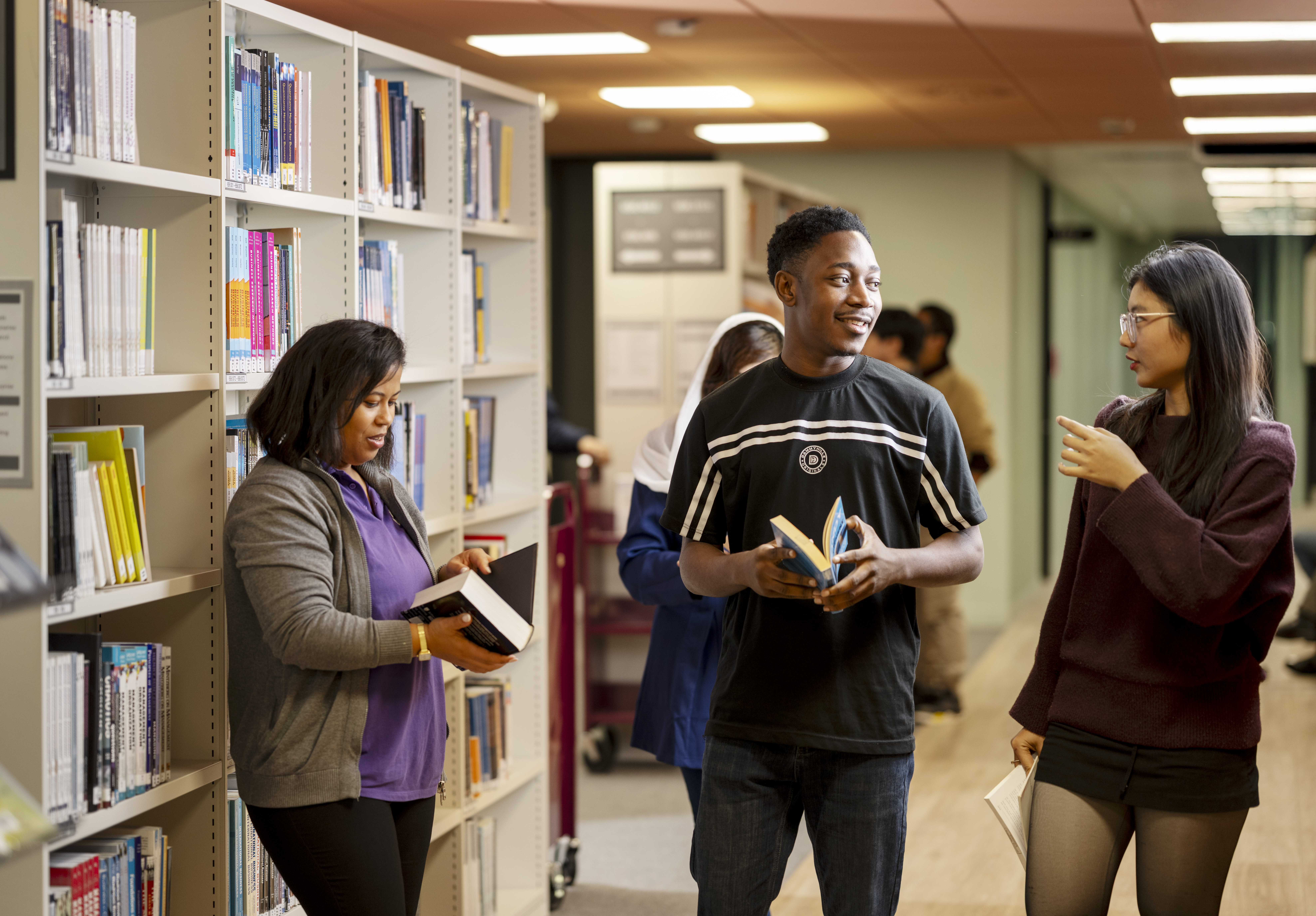 A group of students amongst bookshelves