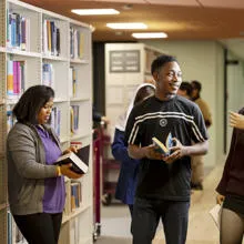 A group of students amongst bookshelves