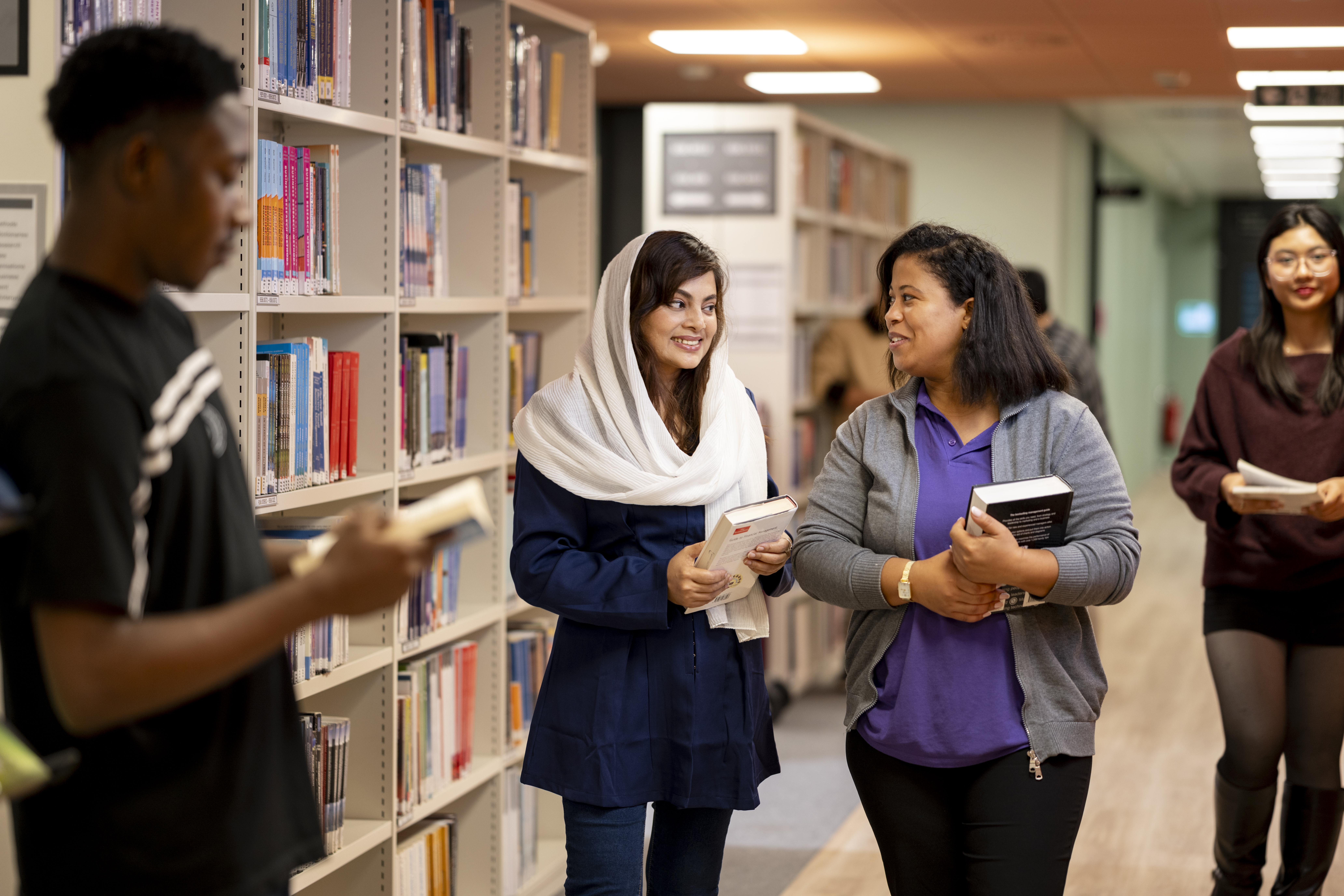 A group of students amongst bookshelves