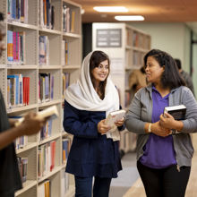 A group of students amongst bookshelves
